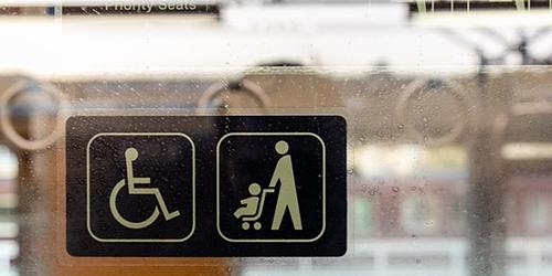 disabled passenger and parent child priority sticker on window of public transport 